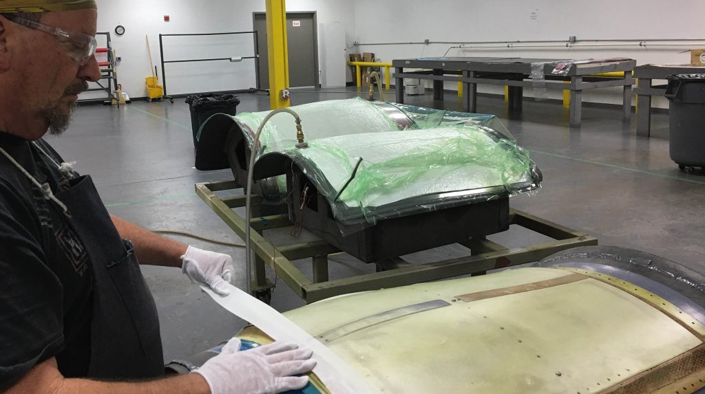 Technician laying up the back skins on a CRJ 100/200 Inlet in our lay-up room