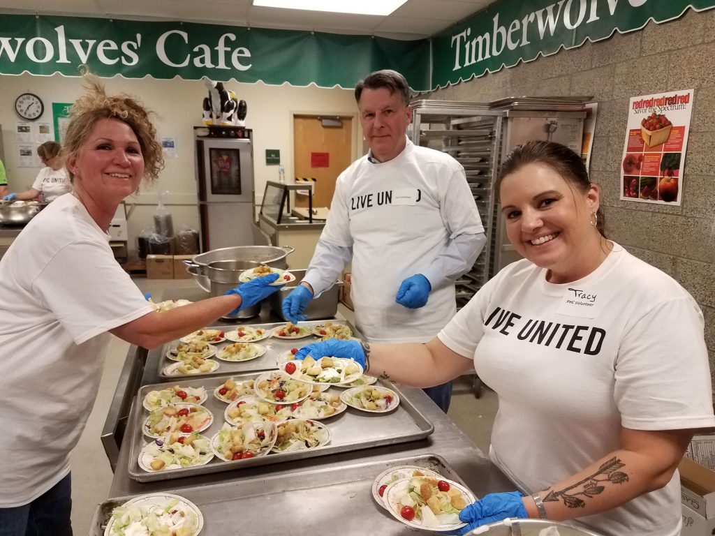 ATS partners Rosemary, Clark, and Tracy serve up salad for clients at the July 2017 Project Homeless Connect event.