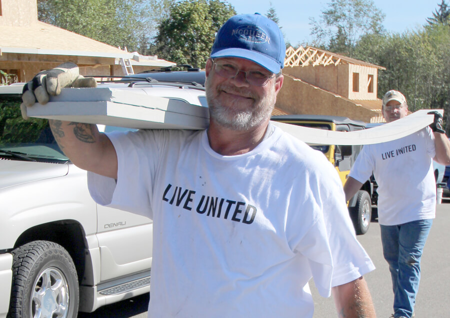 ATS partners Jerry and Sjaan move building materials at the 2015 Day of Caring with Housing Hope