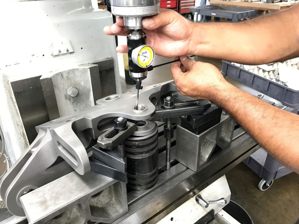 Technician indicating bushings in a 737 NG aft engine mount, prior to line-reaming.